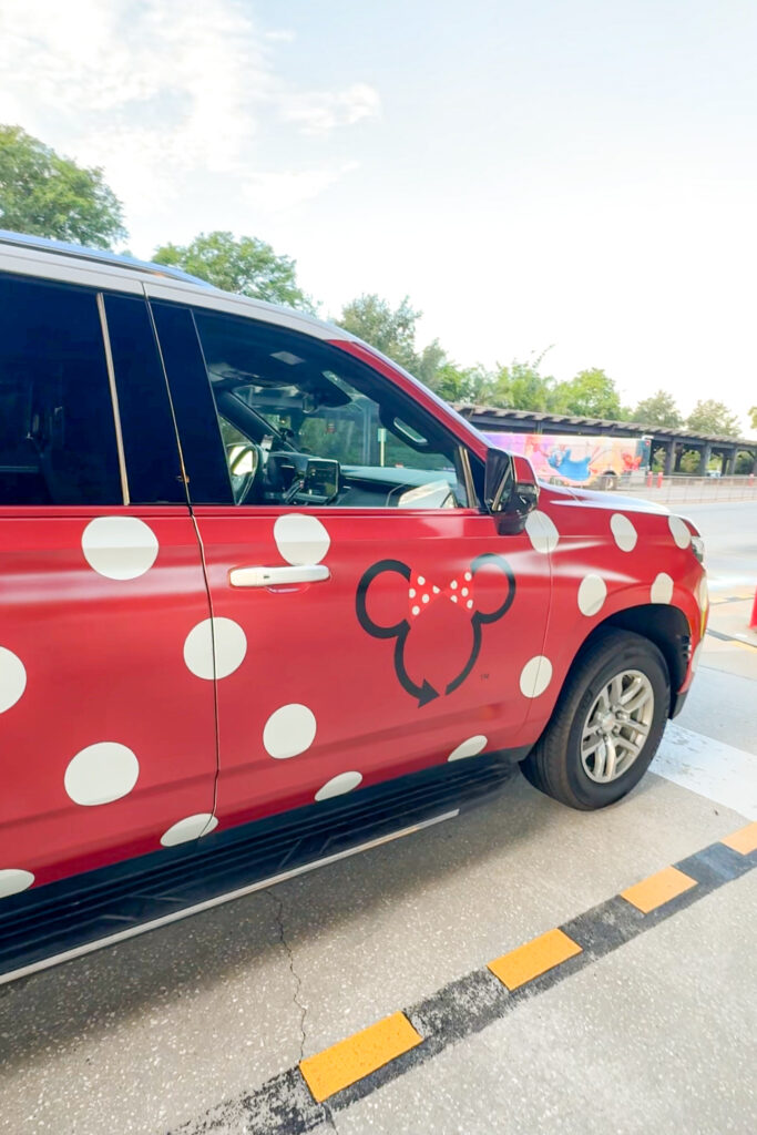A side view of a Disney Minnie Van on the road