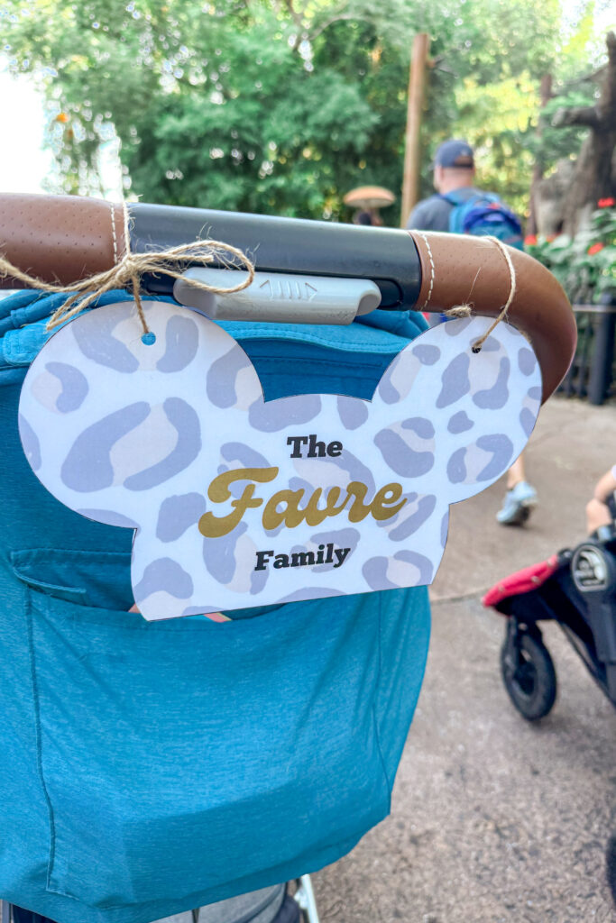Blue stroller with a Mickey-shaped stroller tag attached for quick recognition