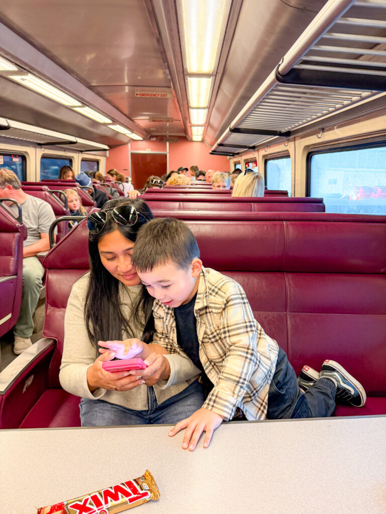A mom and son take the commuter train from Boston to Salem