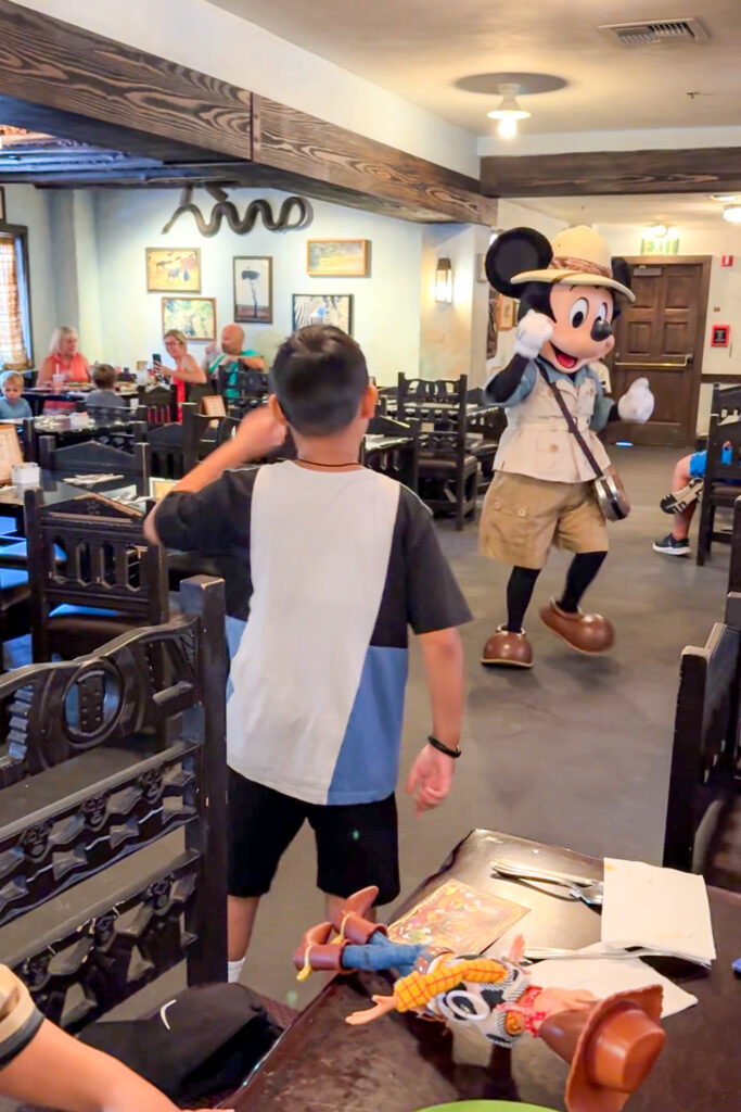 Cast member serving guests at Tusker House buffet inside Disney’s Animal Kingdom.