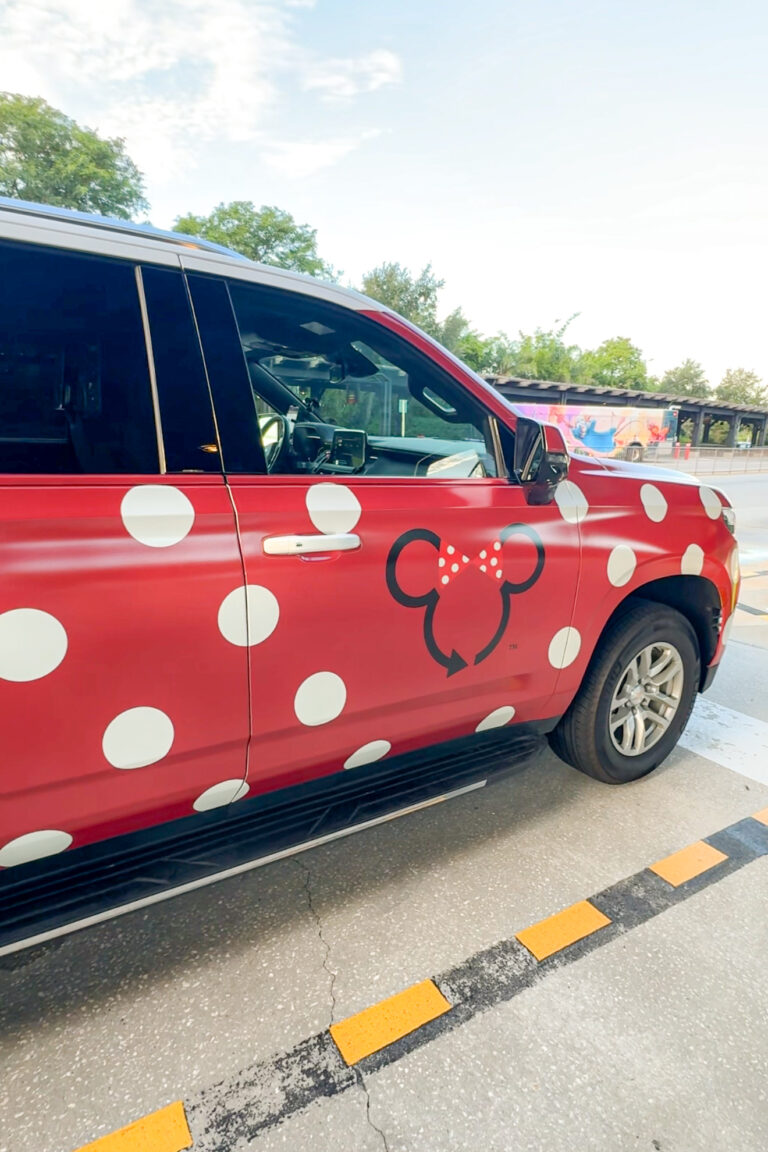 A close up of a Disney Minnie Van, a large SUV wrapped in red with white polkdots