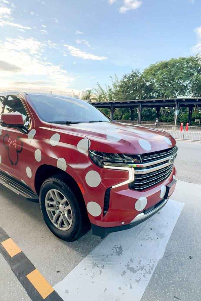 A close up of a Disney Minnie Van, a large SUV wrapped in red with white polkdots